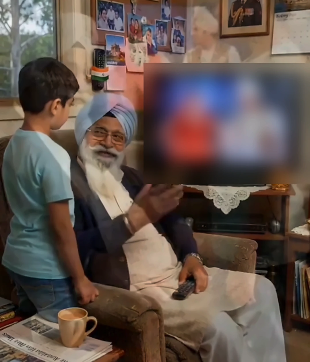 Punjabi grandfather and grandson chatting while watching TV together in the living room